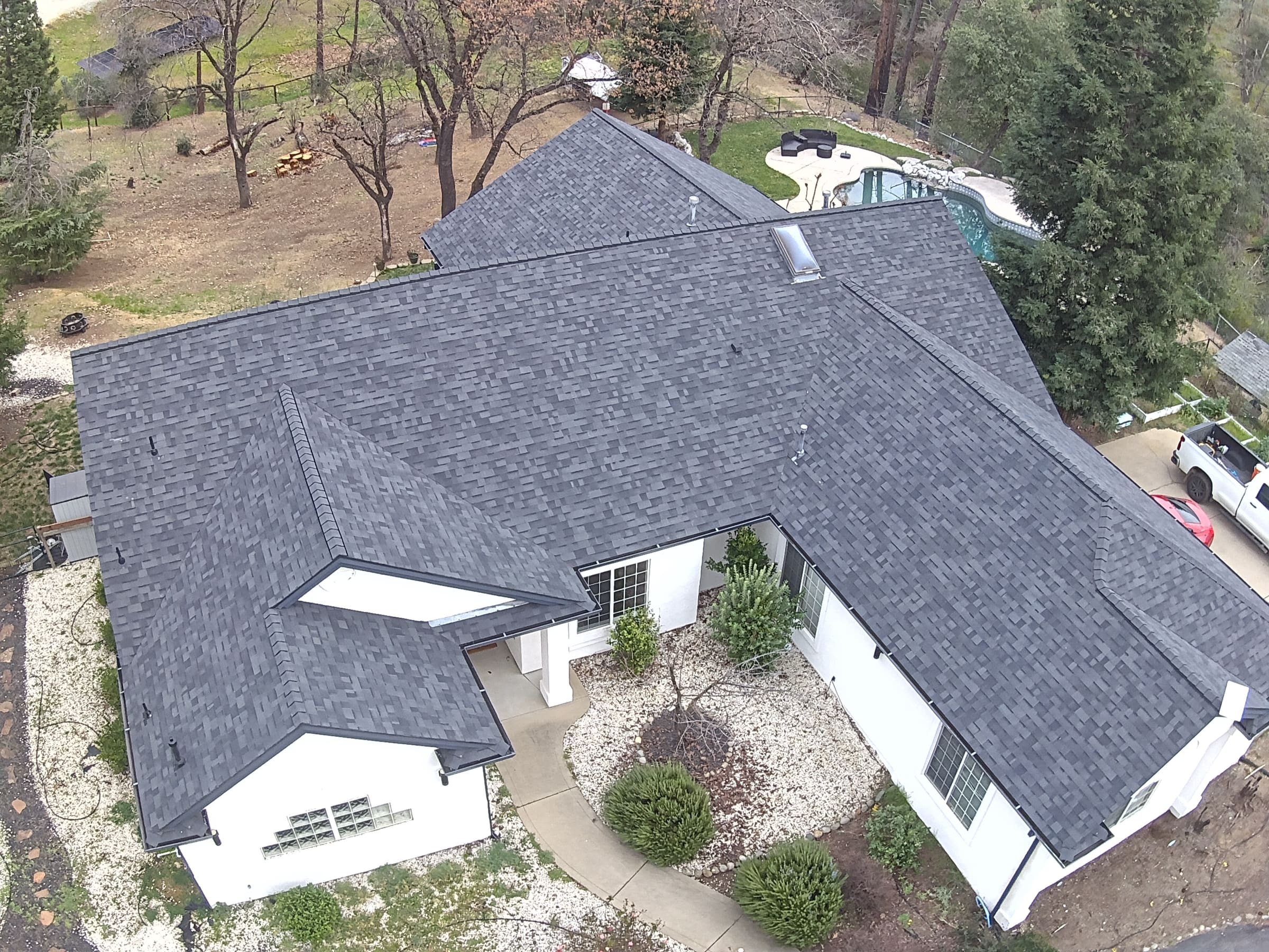 Completed asphalt shingle roof replacement on a Redding-area home