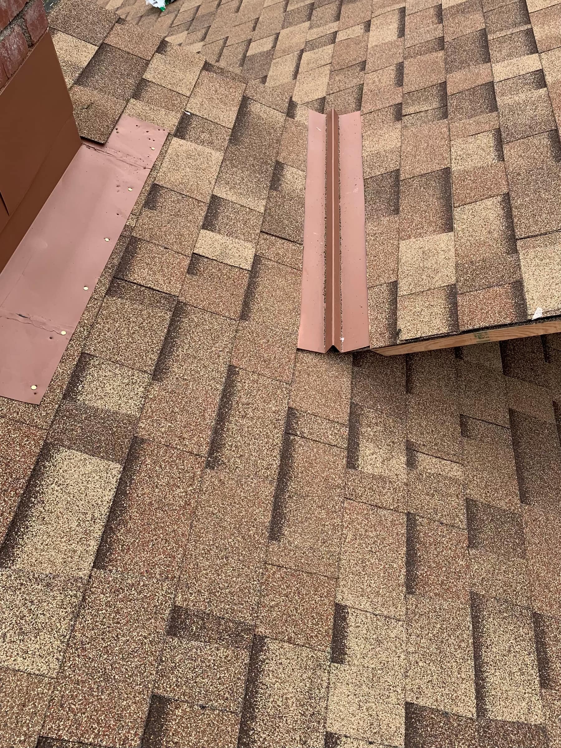 Close-up of hip ridge flashing detail during a shingle roof install