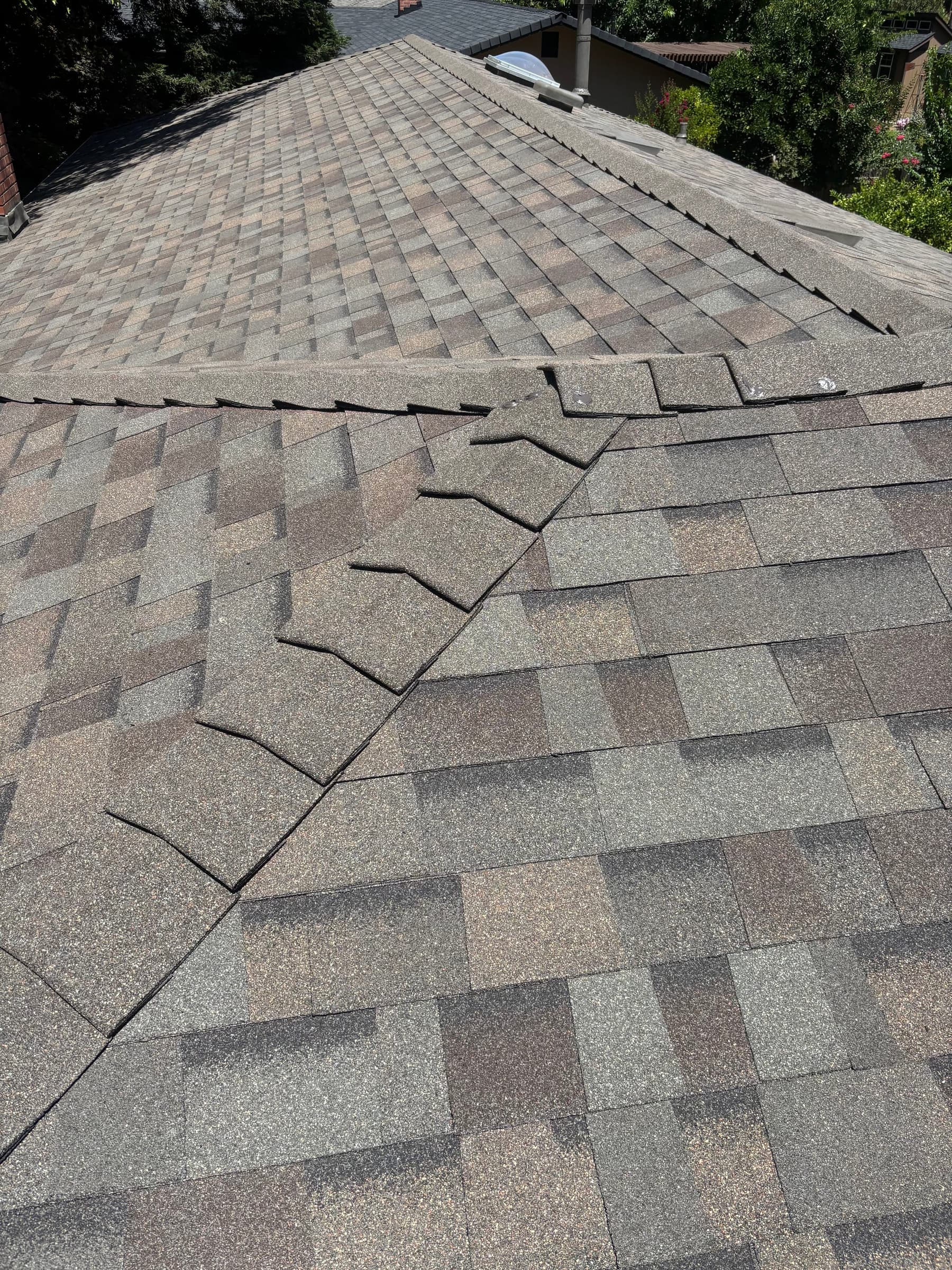 Finished shingle roof ridge line after a full re-roof