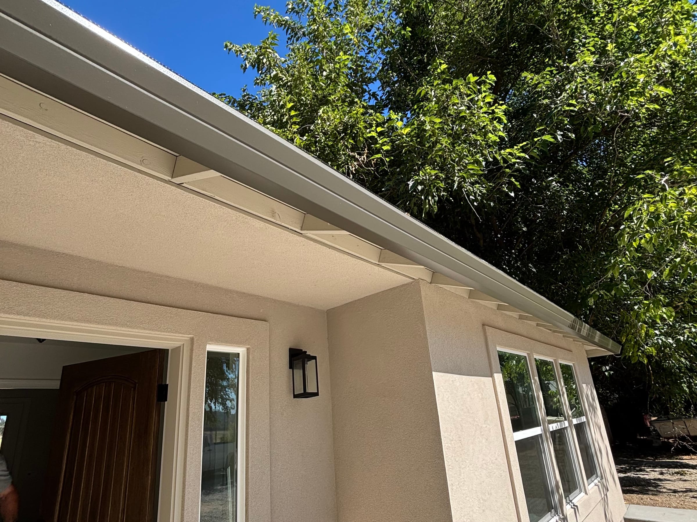 Deep fascia-style gutter profile along a finished roofline