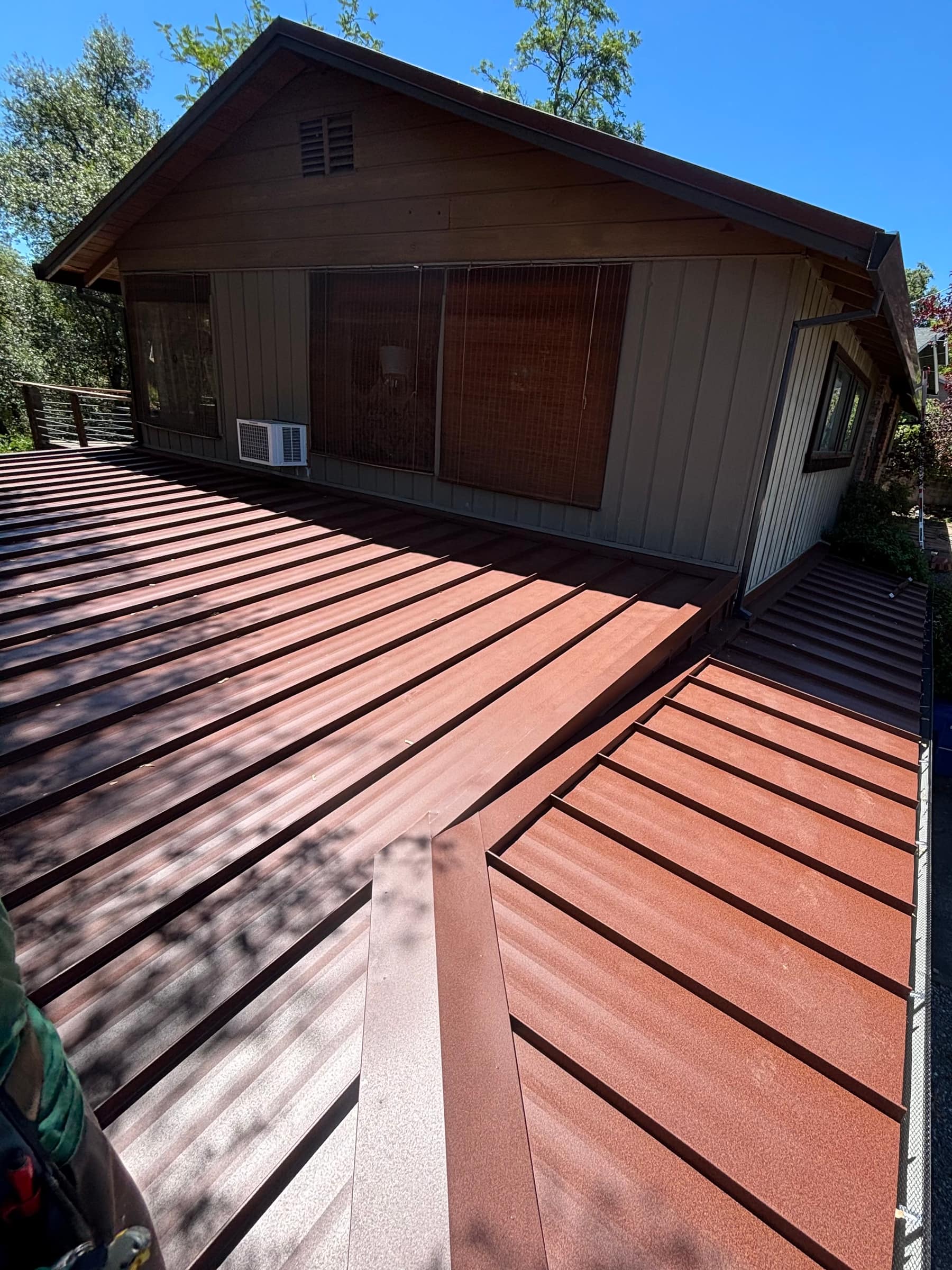 Close-up of a standing-seam metal roof valley on a cabin-style home
